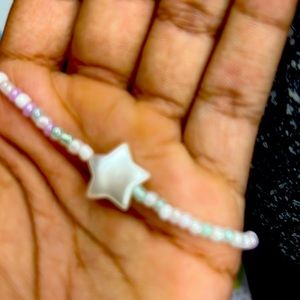 Beaded purple,white, blue necklace including a star.